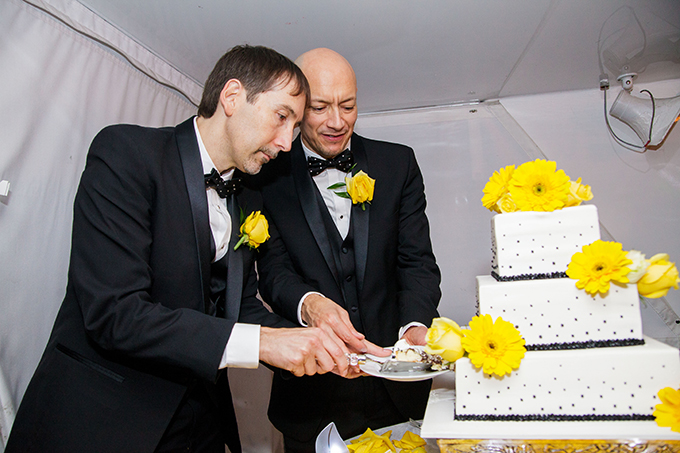 LGBT couple cutting their wedding cake - Charter Yachts of Newport Beach