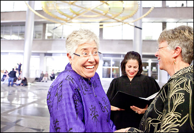 Alison Rose Photography - Photo of happy lesbians and wedding officiant