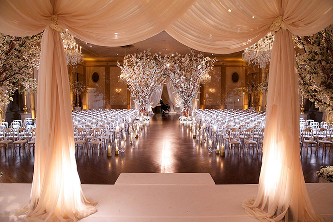 Purple orchid Wedding - Wedding ceremony venue pink drapery and lighted white orchid trees