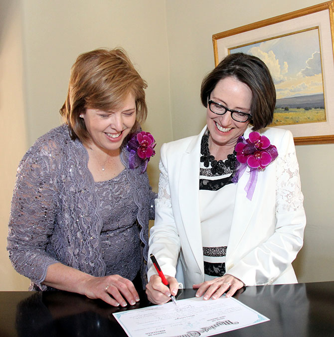 Ricci Photography New Mexico - Lesbian couple signing marriage certificate