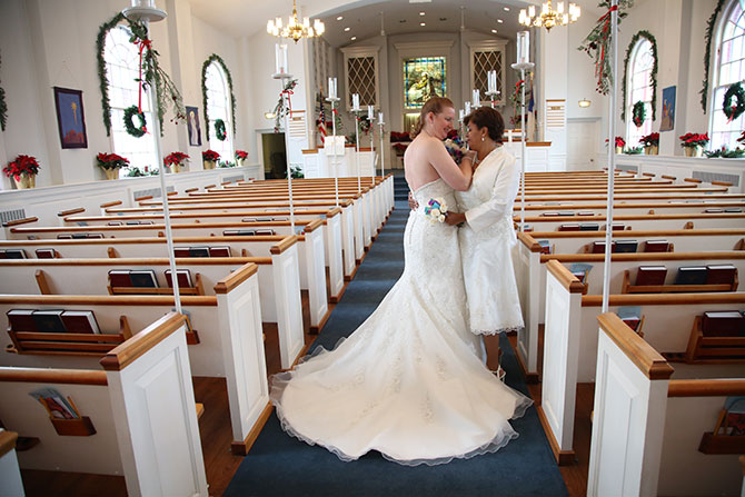 Rick Helman Photography + Video - Candid photo of brides in the church