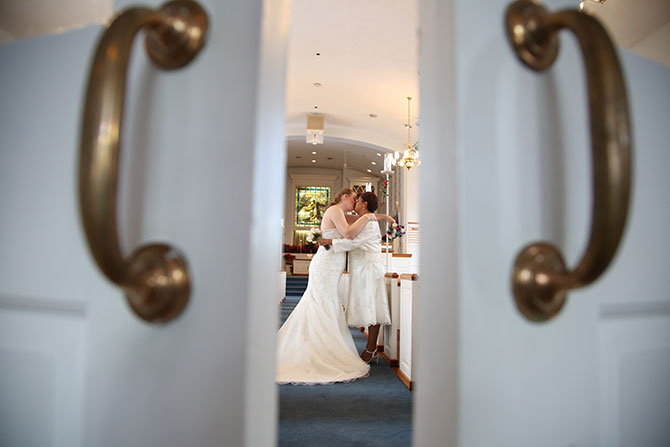 Rick Helman Photography + Video - Creative frame of brides kiss