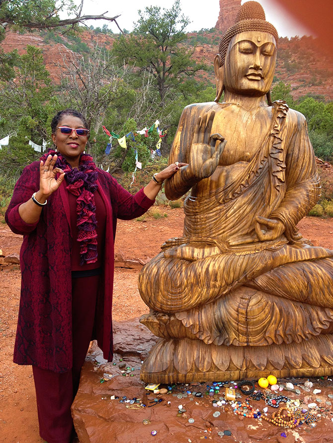 Enlightened Ceremonies - Rev. Angela Airall with Buddah Statue