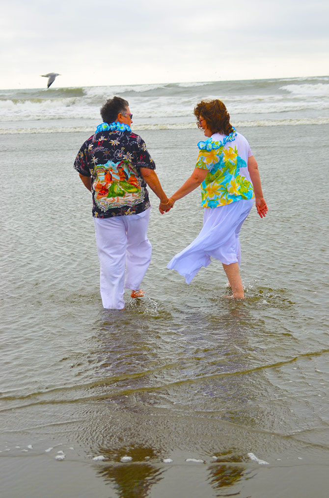 Weddings By The Sea - Lesbian brides walking in the surf