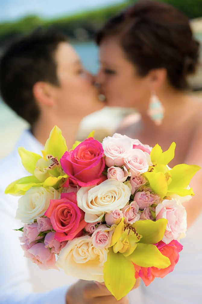 Marry Me Maui Wedding Planners - lgbt brides kissing with flowers