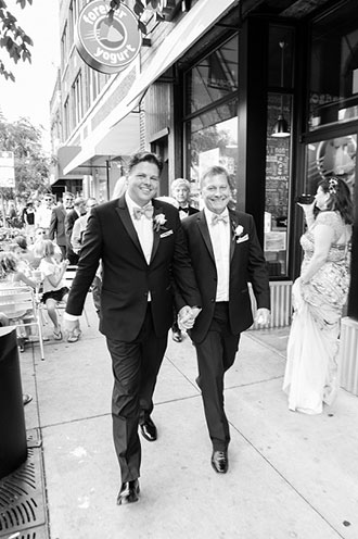 Tasty Catering - same-sex couple in tuxedos walking down a Chicago street