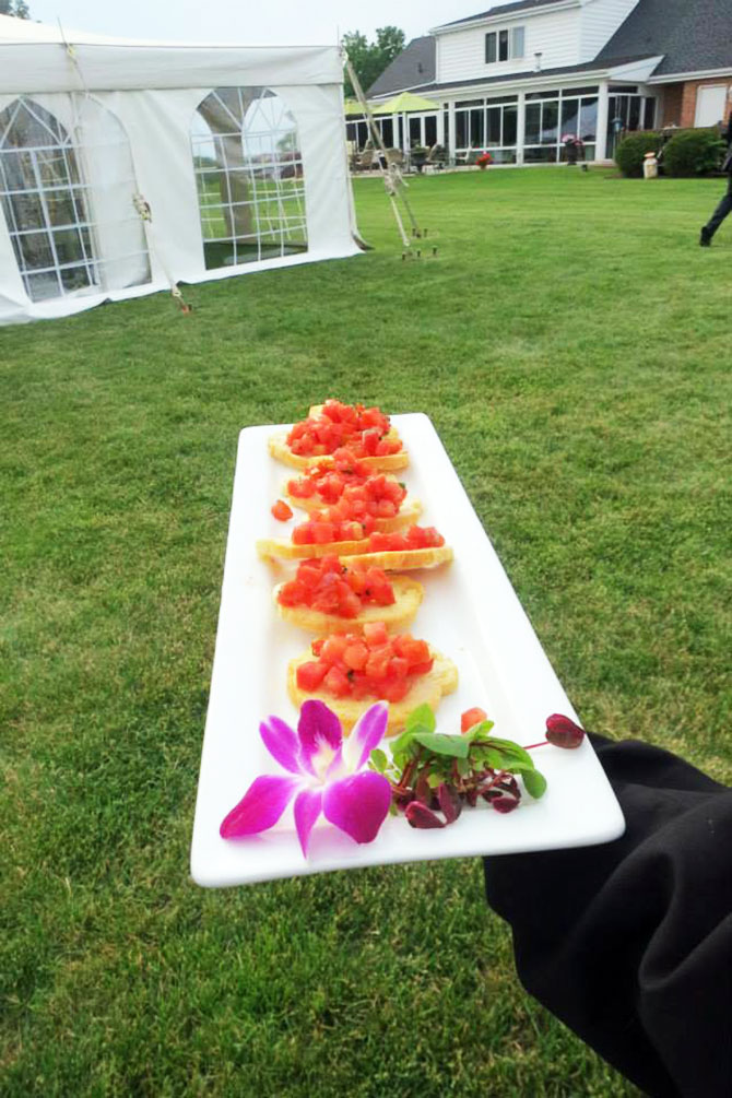 Tasty Catering - plated bruschetta on the way to the wedding tent